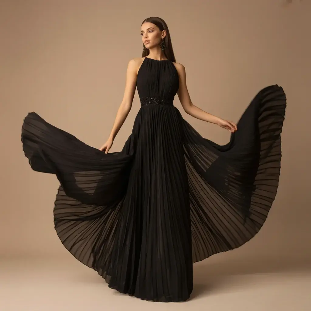 13 Black Long Dresses for Wedding Guests 13 Black pleated chiffon evening gown with flowing movement and textured details